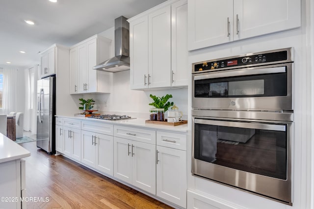 37 Longwood Dr, Monroe, NJ 08831 - kitchen featuring appliances with stainless steel finishes, wall chimney exhaust hood, light countertops, white cabinetry, and recessed lighting