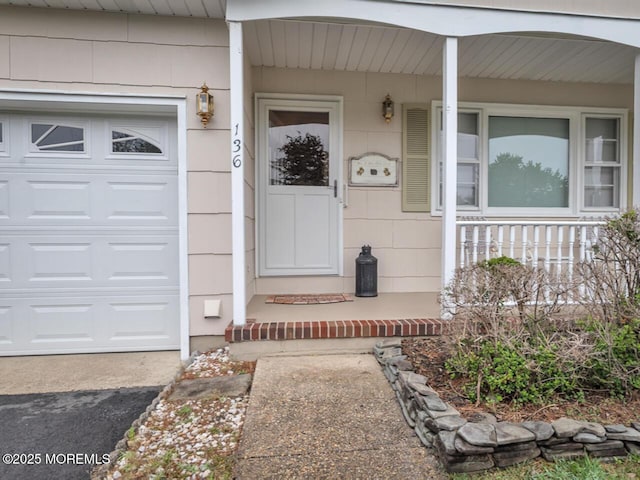 136 Georgetown Rd, Toms River, NJ 08757 - view of exterior entry with a porch and an attached garage