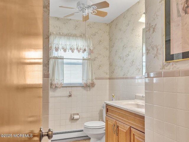 136 Georgetown Rd, Toms River, NJ 08757 - bathroom with a baseboard heating unit, vanity, tile walls, ceiling fan, and a wainscoted wall