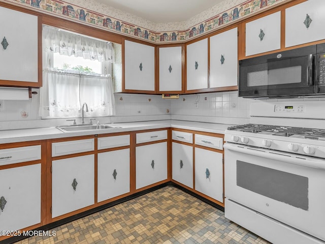 136 Georgetown Rd, Toms River, NJ 08757 - kitchen with white gas range, black microwave, light countertops, and decorative backsplash