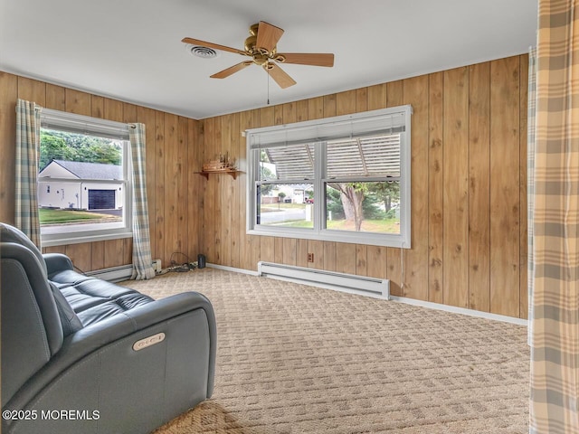 136 Georgetown Rd, Toms River, NJ 08757 - living room with a baseboard radiator, a ceiling fan, wooden walls, and carpet flooring
