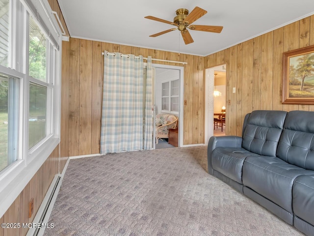 136 Georgetown Rd, Toms River, NJ 08757 - living room featuring wood walls, ornamental molding, a baseboard heating unit, ceiling fan, and carpet flooring