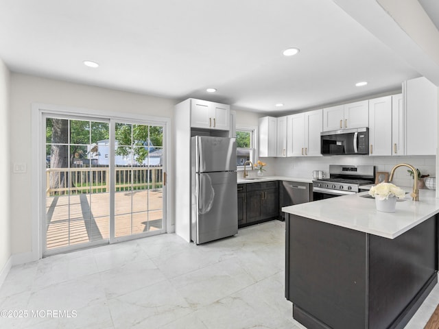 37 Bryant Dr, Jackson, NJ 08527 - kitchen with stainless steel appliances, a peninsula, light countertops, recessed lighting, and light marble finish floors