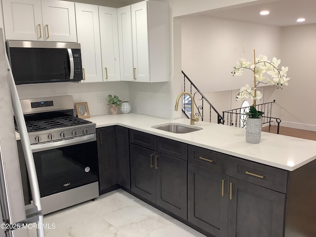 37 Bryant Dr, Jackson, NJ 08527 - kitchen featuring stainless steel appliances, a peninsula, white cabinets, light countertops, and light marble finish floors