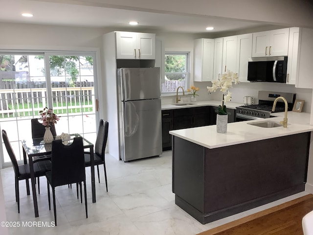37 Bryant Dr, Jackson, NJ 08527 - kitchen with stainless steel appliances, a peninsula, light countertops, white cabinets, and recessed lighting