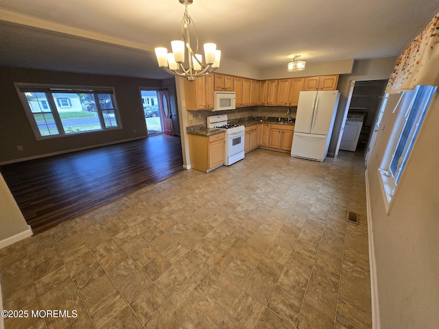 1236 Bewick St, Toms River, NJ 08753 - kitchen with white appliances, open floor plan, a chandelier, dark countertops, and washer / dryer