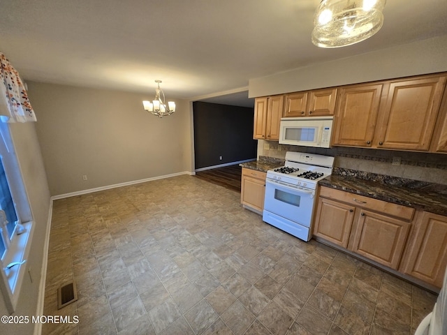 1236 Bewick St, Toms River, NJ 08753 - kitchen with white appliances, a chandelier, tasteful backsplash, stone finish flooring, and decorative light fixtures
