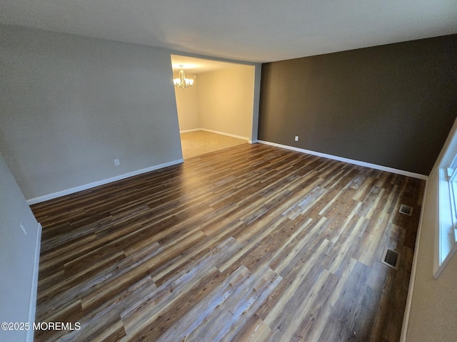 1236 Bewick St, Toms River, NJ 08753 - empty room featuring a chandelier and dark wood-style flooring