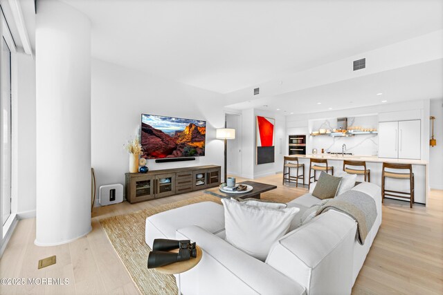 1101 Ocean Ave Unit 1404, Asbury Park, NJ 07712 - living room with light wood-type flooring, recessed lighting, and bar area