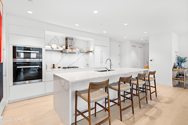 1101 Ocean Ave Unit 1404, Asbury Park, NJ 07712 - kitchen with modern cabinets, white cabinetry, light wood-style flooring, gas stovetop, and recessed lighting