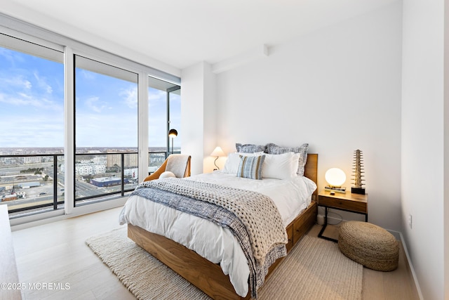 1101 Ocean Ave Unit 1404, Asbury Park, NJ 07712 - bedroom featuring floor to ceiling windows, access to outside, and wood finished floors