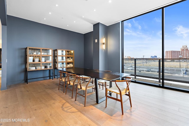 1101 Ocean Ave Unit 1404, Asbury Park, NJ 07712 - dining room featuring a wall of windows, wood-type flooring, a view of city, and recessed lighting