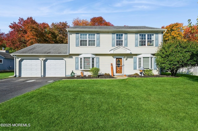 128 Oak Glen Rd, Toms River, NJ 08753 - colonial house with an attached garage, asphalt driveway, a front lawn, and roof with shingles