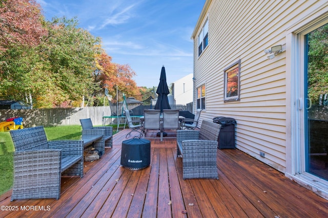 128 Oak Glen Rd, Toms River, NJ 08753 - deck with outdoor dining space, a trampoline, and a fenced backyard