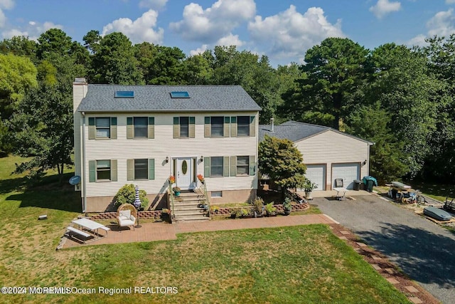 9 Tracy Pl, Jackson, NJ 08527 - colonial inspired home with a chimney, a front yard, asphalt driveway, an attached garage, and view of wooded area