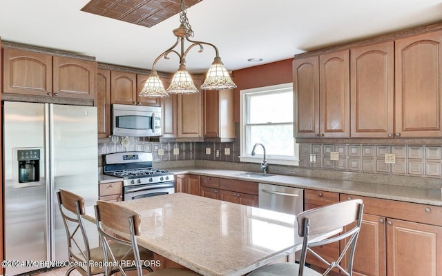 9 Tracy Pl, Jackson, NJ 08527 - kitchen featuring stainless steel appliances, a breakfast bar area, tasteful backsplash, and a center island