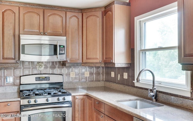 9 Tracy Pl, Jackson, NJ 08527 - kitchen with appliances with stainless steel finishes, backsplash, and light stone counters