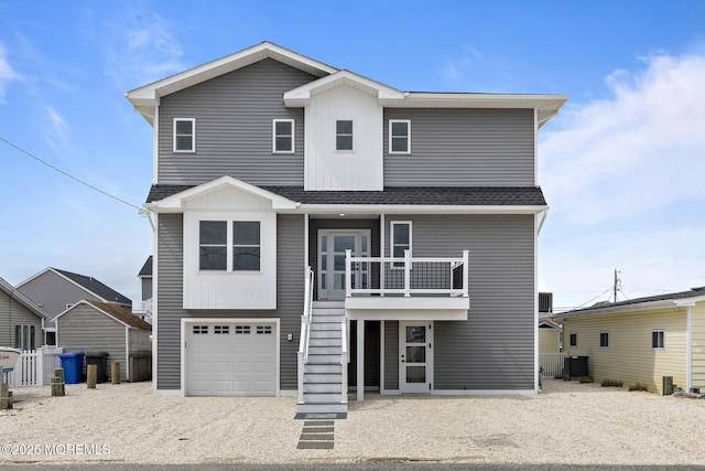 56 Gregg Dr, Beach Haven West, NJ 08050 - view of front of home featuring stairway, roof with shingles, gravel driveway, and an attached garage