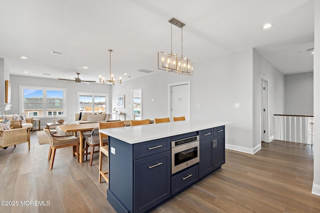 56 Gregg Dr, Beach Haven West, NJ 08050 - kitchen with wood finished floors, a chandelier, a kitchen island, open floor plan, and recessed lighting
