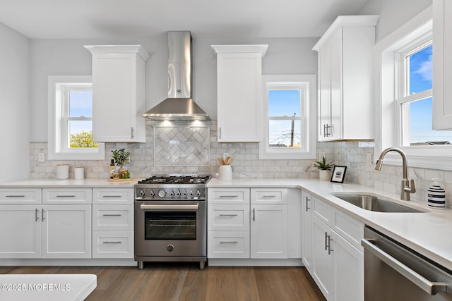 56 Gregg Dr, Beach Haven West, NJ 08050 - kitchen with appliances with stainless steel finishes, wall chimney exhaust hood, white cabinetry, light countertops, and backsplash