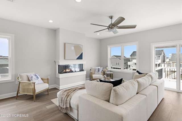 56 Gregg Dr, Beach Haven West, NJ 08050 - living room with wood finished floors, a multi sided fireplace, a ceiling fan, and recessed lighting