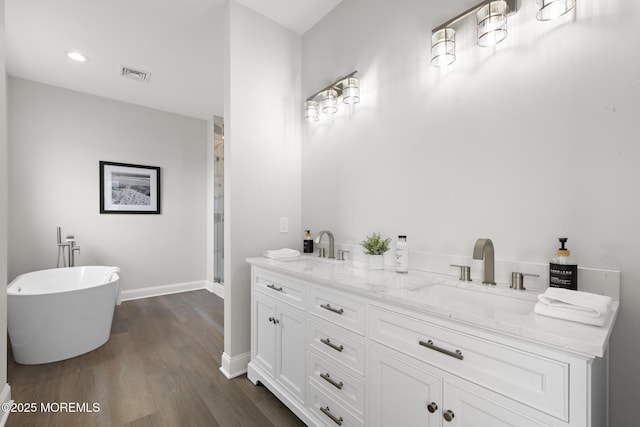 56 Gregg Dr, Beach Haven West, NJ 08050 - bathroom with wood finished floors, a freestanding tub, a shower stall, double vanity, and recessed lighting