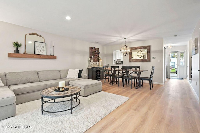 49 Scarborough Ct Unit 3, Freehold, NJ 07728 - living room with light wood finished floors, a chandelier, and recessed lighting