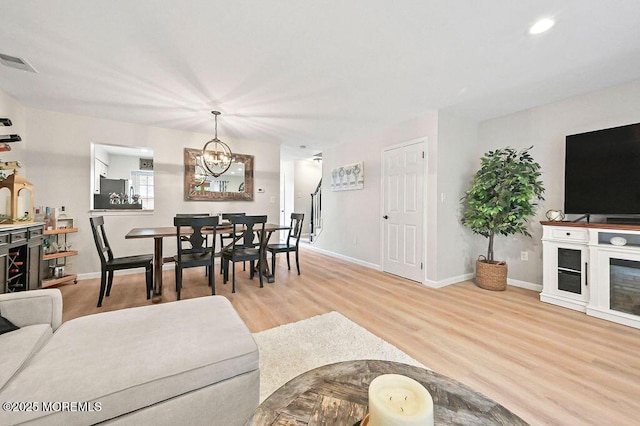 49 Scarborough Ct Unit 3, Freehold, NJ 07728 - living room with a chandelier, wood finished floors, and recessed lighting