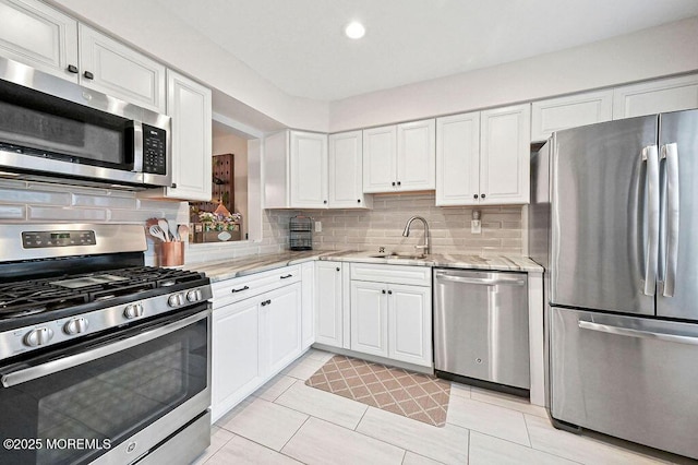 49 Scarborough Ct Unit 3, Freehold, NJ 07728 - kitchen with appliances with stainless steel finishes, white cabinetry, tasteful backsplash, light stone countertops, and recessed lighting