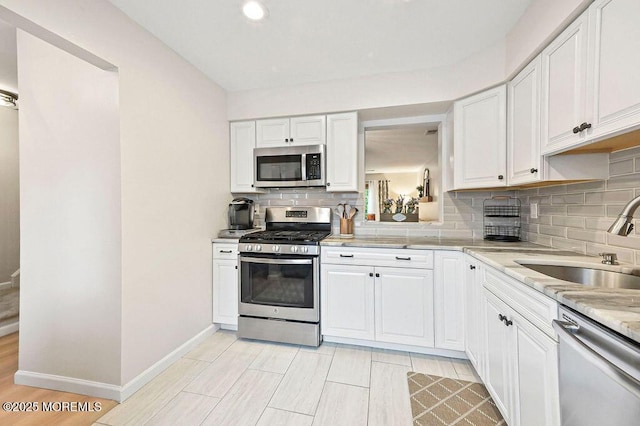 49 Scarborough Ct Unit 3, Freehold, NJ 07728 - kitchen featuring stainless steel appliances, light countertops, decorative backsplash, white cabinetry, and recessed lighting