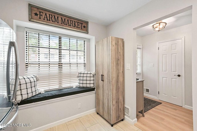 49 Scarborough Ct Unit 3, Freehold, NJ 07728 - interior space with healthy amount of natural light, light wood finished floors, and stainless steel refrigerator