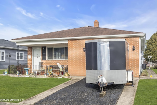 8 Tijuana Ct, Toms River, NJ 08757 - rear view of property with brick siding, a yard, a chimney, covered porch, and roof with shingles