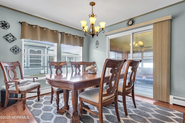 8 Tijuana Ct, Toms River, NJ 08757 - dining room featuring a chandelier, healthy amount of natural light, wood finished floors, crown molding, and baseboard heating