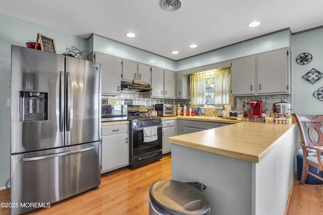 8 Tijuana Ct, Toms River, NJ 08757 - kitchen with stainless steel fridge, black range with gas cooktop, a peninsula, gray cabinets, and light wood-style floors
