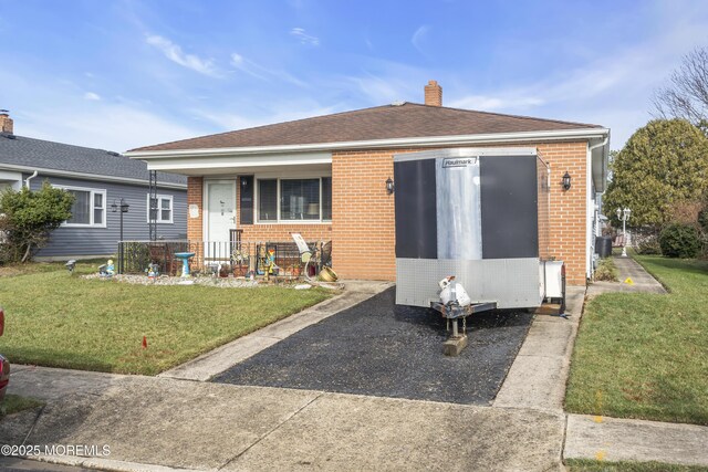 8 Tijuana Ct, Toms River, NJ 08757 - rear view of house with brick siding, a lawn, and a chimney