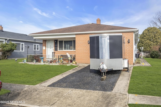 8 Tijuana Ct, Toms River, NJ 08757 - back of property with brick siding, a yard, a chimney, and a porch