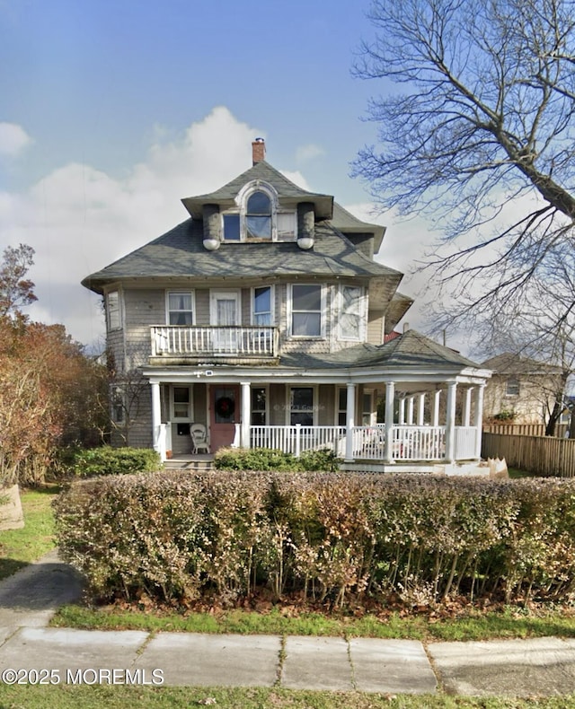 23 Milan Pl, Deal, NJ 07723 - view of front of house featuring covered porch, a chimney, and a balcony