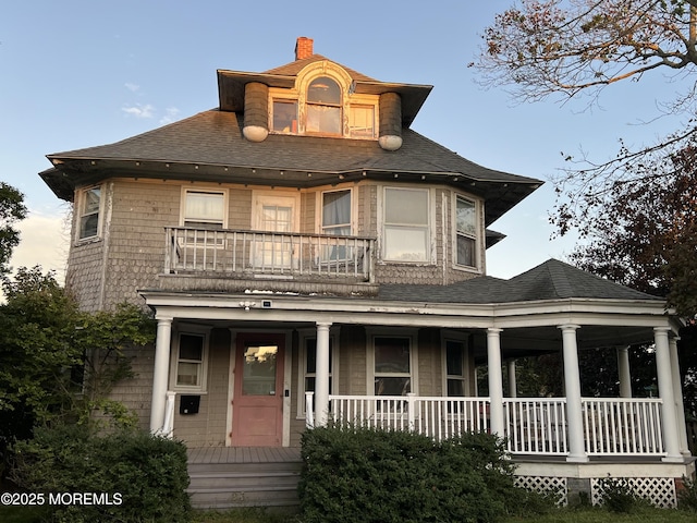 23 Milan Pl, Deal, NJ 07723 - view of front facade with a porch, a balcony, roof with shingles, and a chimney