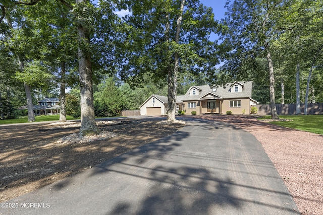 1792 Todd Rd, Toms River, NJ 08755 - cape cod house featuring driveway, a garage, and view of scattered trees