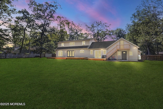 1792 Todd Rd, Toms River, NJ 08755 - back of property at dusk with a deck, a fenced backyard, and french doors