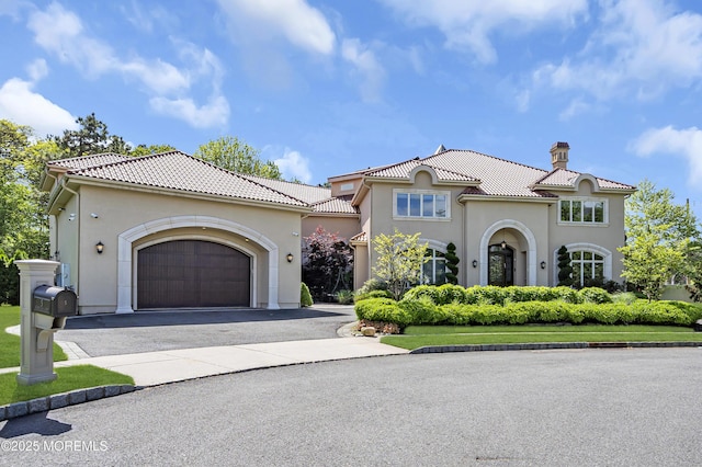 5 Champlain Ct, Lakewood, NJ 08701 - mediterranean / spanish home featuring a chimney, driveway, a tile roof, and stucco siding