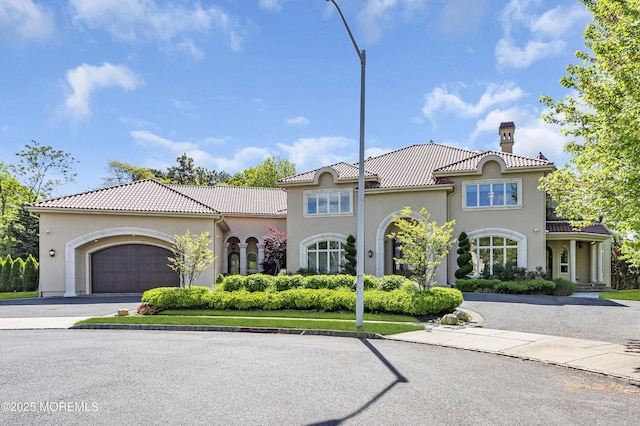 5 Champlain Ct, Lakewood, NJ 08701 - mediterranean / spanish home with a chimney, a garage, stucco siding, and a tile roof