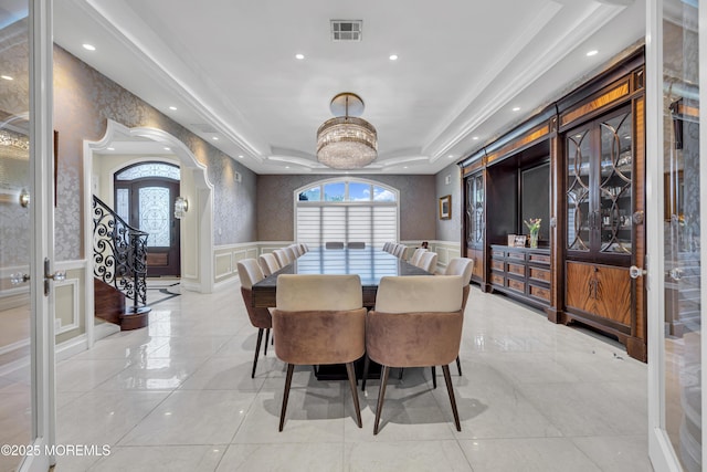 5 Champlain Ct, Lakewood, NJ 08701 - dining space featuring arched walkways, a decorative wall, a wainscoted wall, and recessed lighting