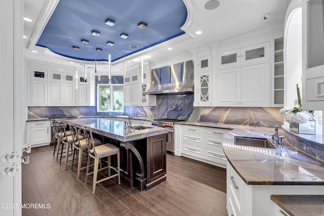 5 Champlain Ct, Lakewood, NJ 08701 - kitchen featuring stainless steel range, wall chimney exhaust hood, a tray ceiling, an island with sink, and crown molding