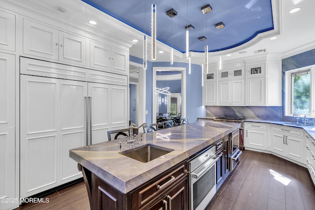 5 Champlain Ct, Lakewood, NJ 08701 - kitchen featuring an island with sink, white cabinetry, recessed lighting, dark wood-type flooring, and hanging light fixtures