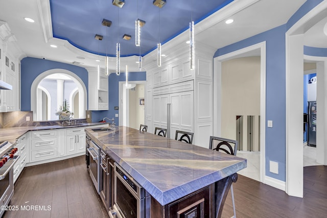 5 Champlain Ct, Lakewood, NJ 08701 - kitchen featuring a center island with sink, white cabinets, dark wood finished floors, appliances with stainless steel finishes, and recessed lighting