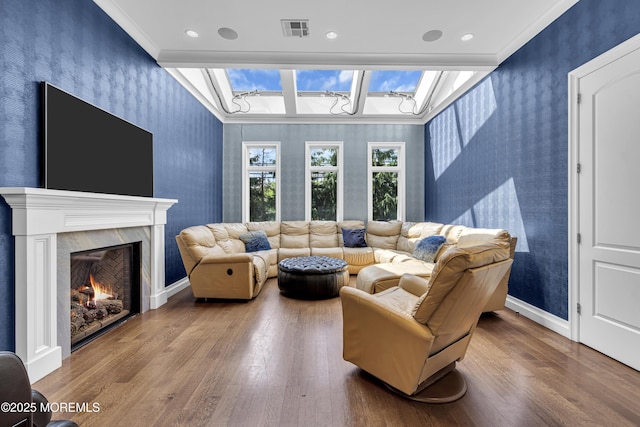 5 Champlain Ct, Lakewood, NJ 08701 - living room featuring wallpapered walls, wood finished floors, crown molding, a high end fireplace, and an accent wall