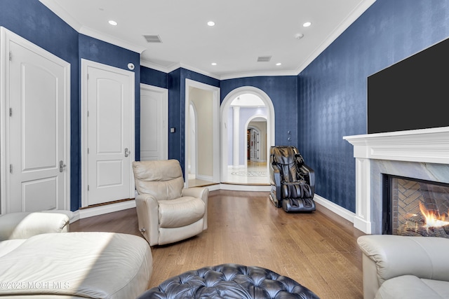 5 Champlain Ct, Lakewood, NJ 08701 - living room featuring wood finished floors, arched walkways, a premium fireplace, recessed lighting, and crown molding