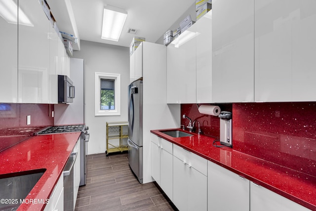 5 Champlain Ct, Lakewood, NJ 08701 - kitchen with appliances with stainless steel finishes, modern cabinets, white cabinets, and decorative backsplash