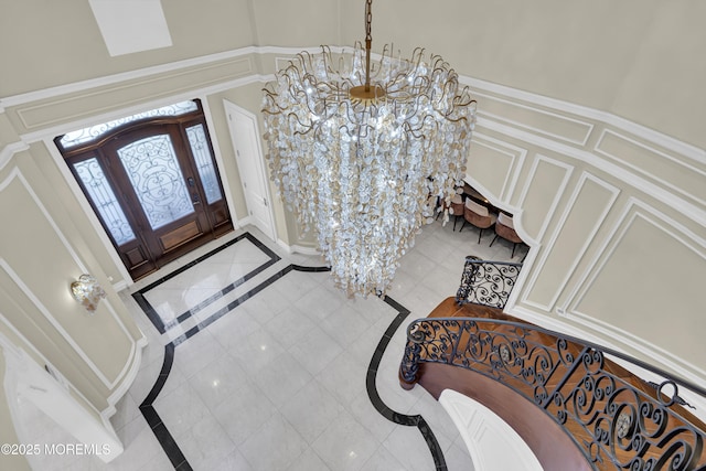 5 Champlain Ct, Lakewood, NJ 08701 - entryway featuring inlaid floor details, a decorative wall, a chandelier, and a towering ceiling